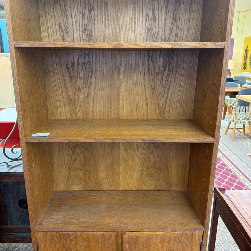 Wooden bookshelf with multiple shelves in a room setting