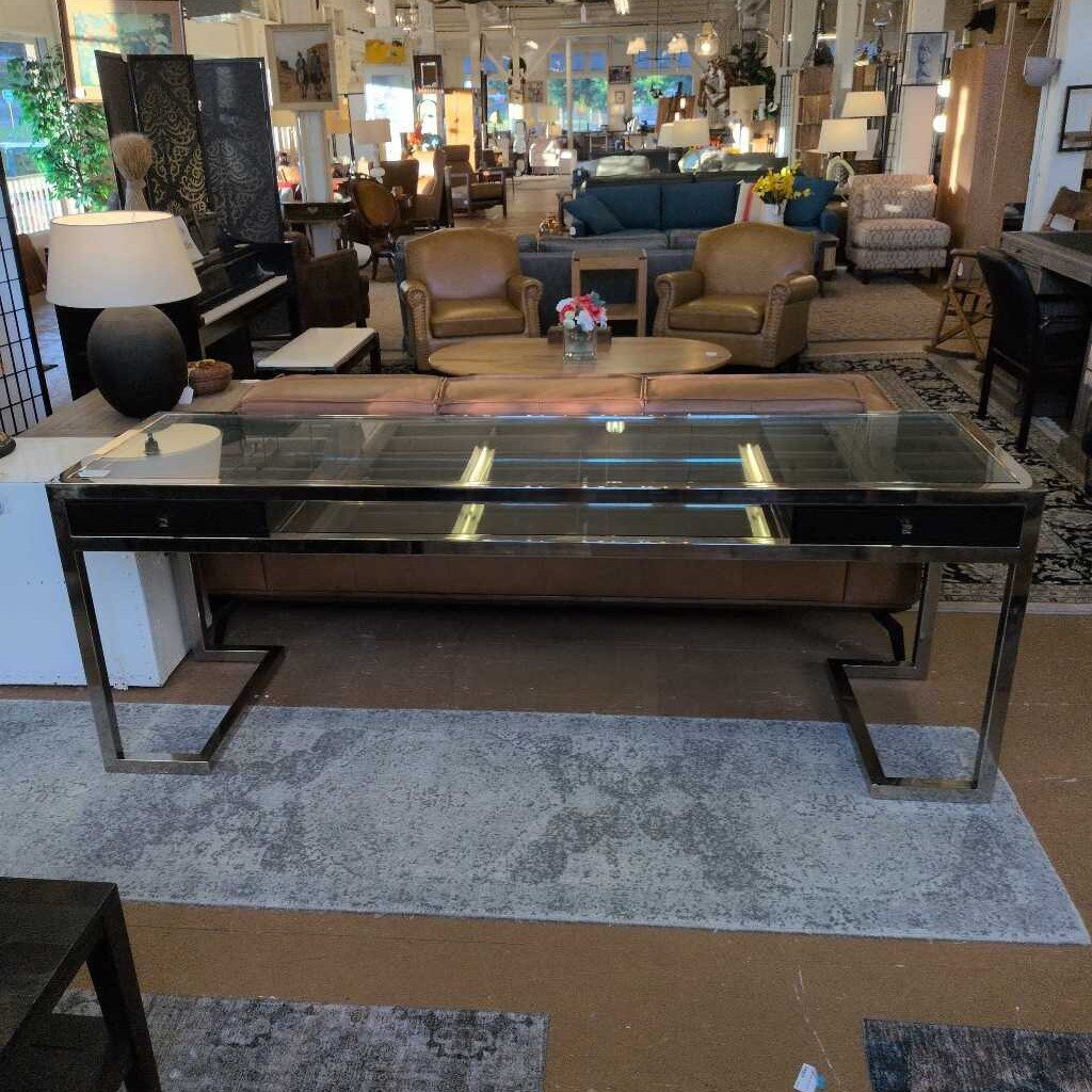 Futuristic table with reflective surface in a furniture store setting