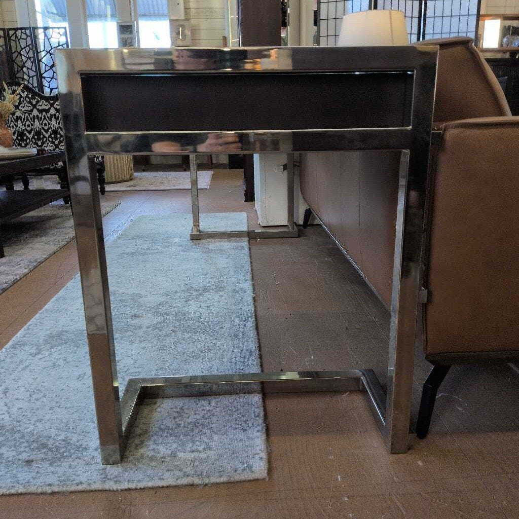 Modern glass table with metal frame in a room setting