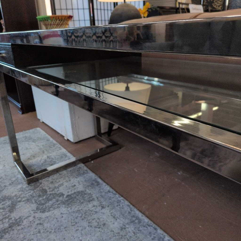 Glass table with metal frame on a wooden floor