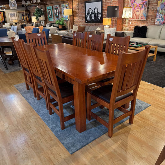 Wooden dining table with chairs in a showroom setting