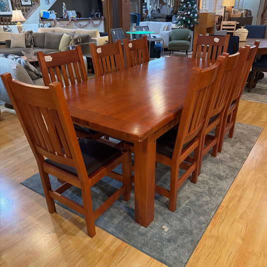 Wooden dining table with chairs in a furniture store setting