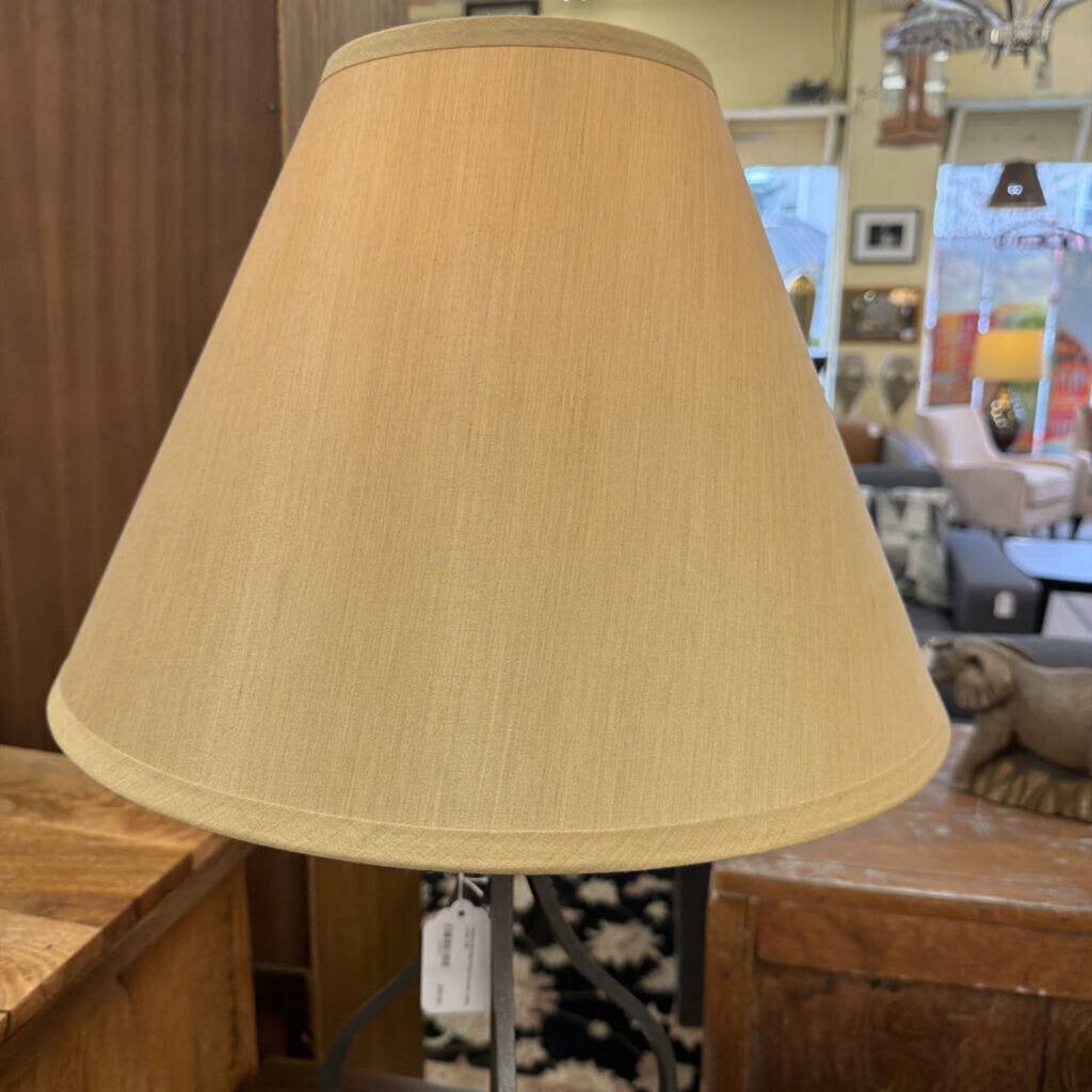 Beige lampshade on a wooden surface with a blurred indoor background