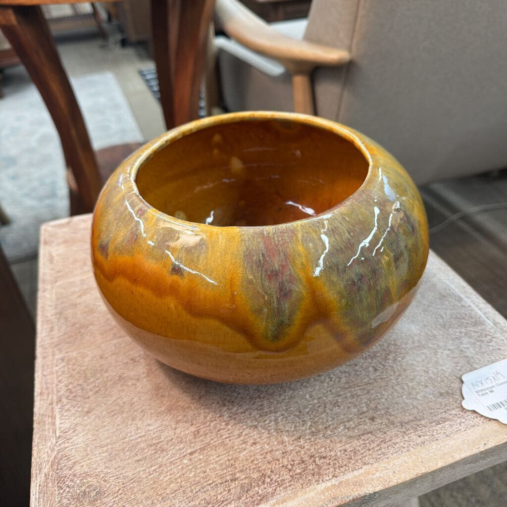 Decorative ceramic bowl with marbled design on a wooden surface