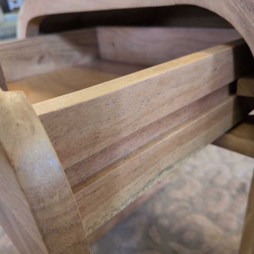 Close-up of a wooden chair with visible grain and texture.