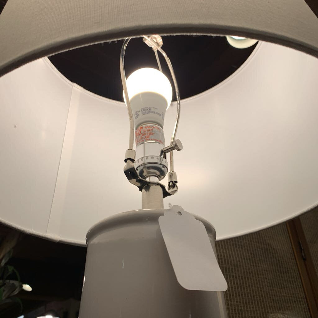 Light bulb inside a lamp with a visible tag on a white background