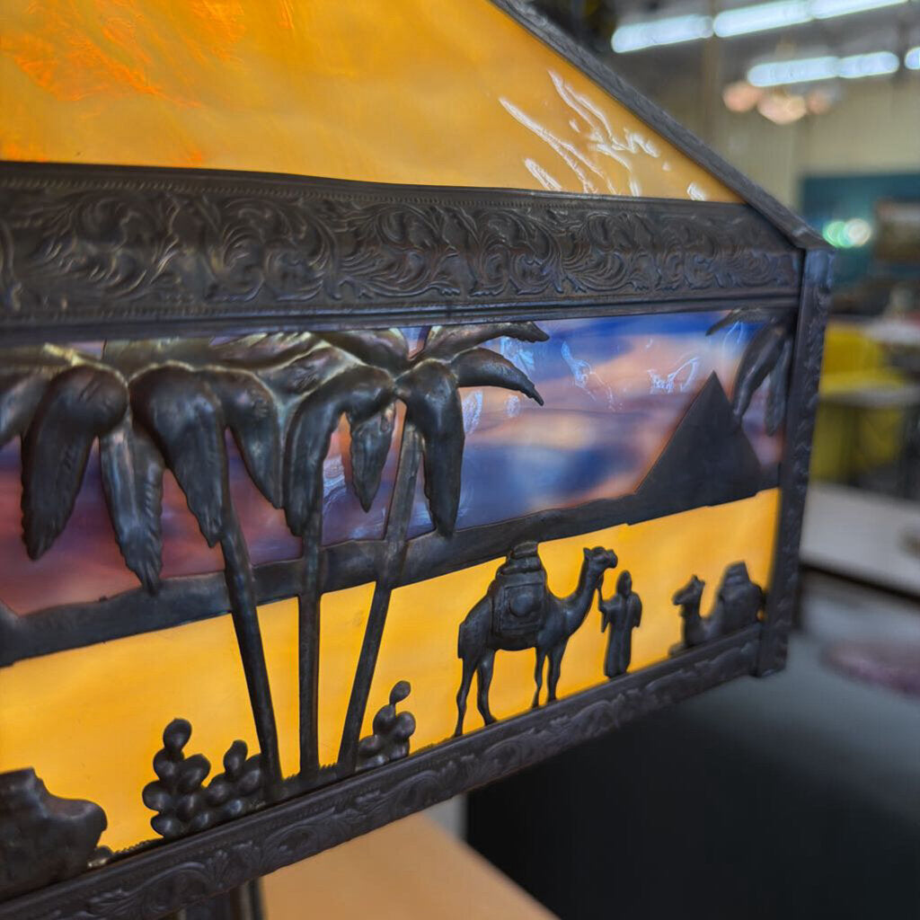 Decorative lamp with palm trees and camels design on a blurred background