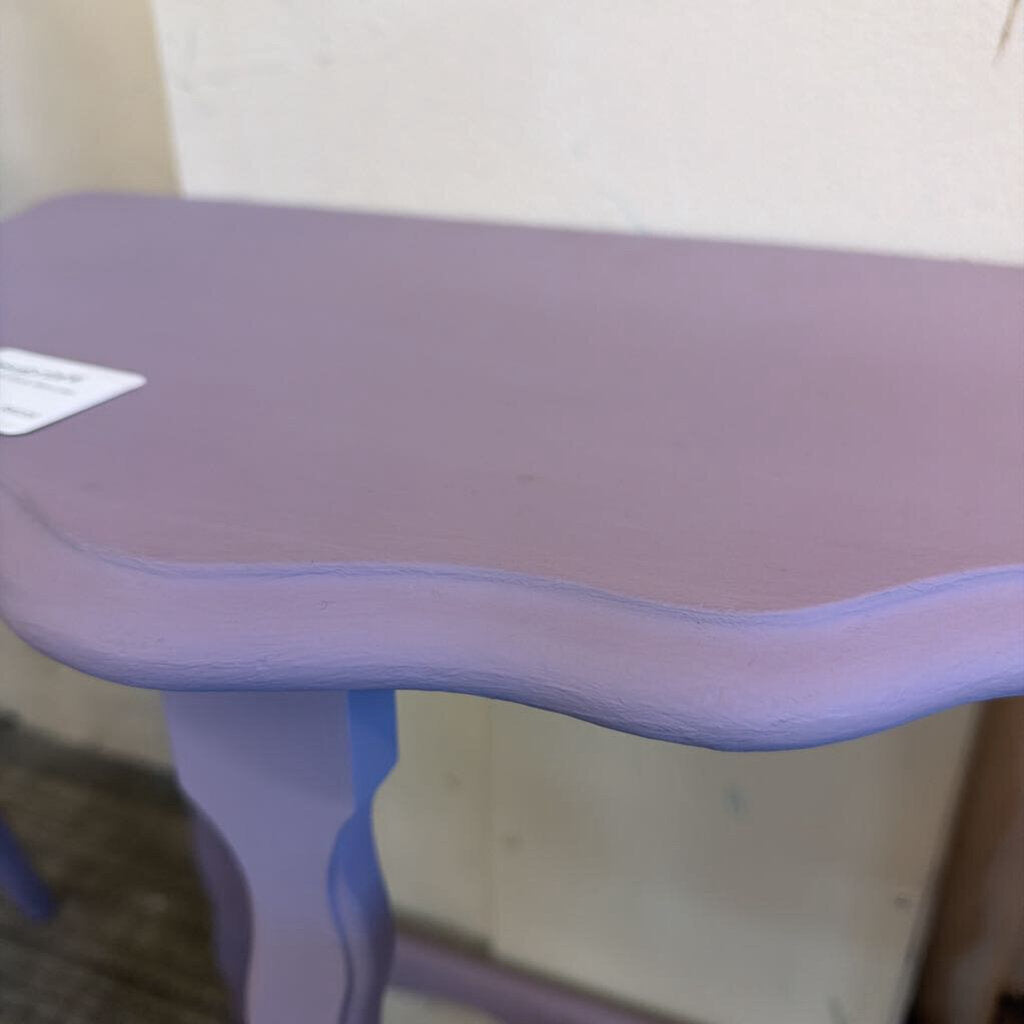 Purple children's desk with a white wall in the background