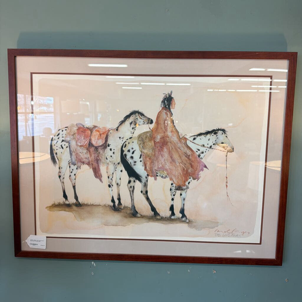 Framed artwork of a person on a horse with a saddle, against a plain background