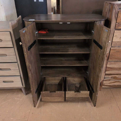 Wooden cabinet with ribbed texture and two doors in a room setting.