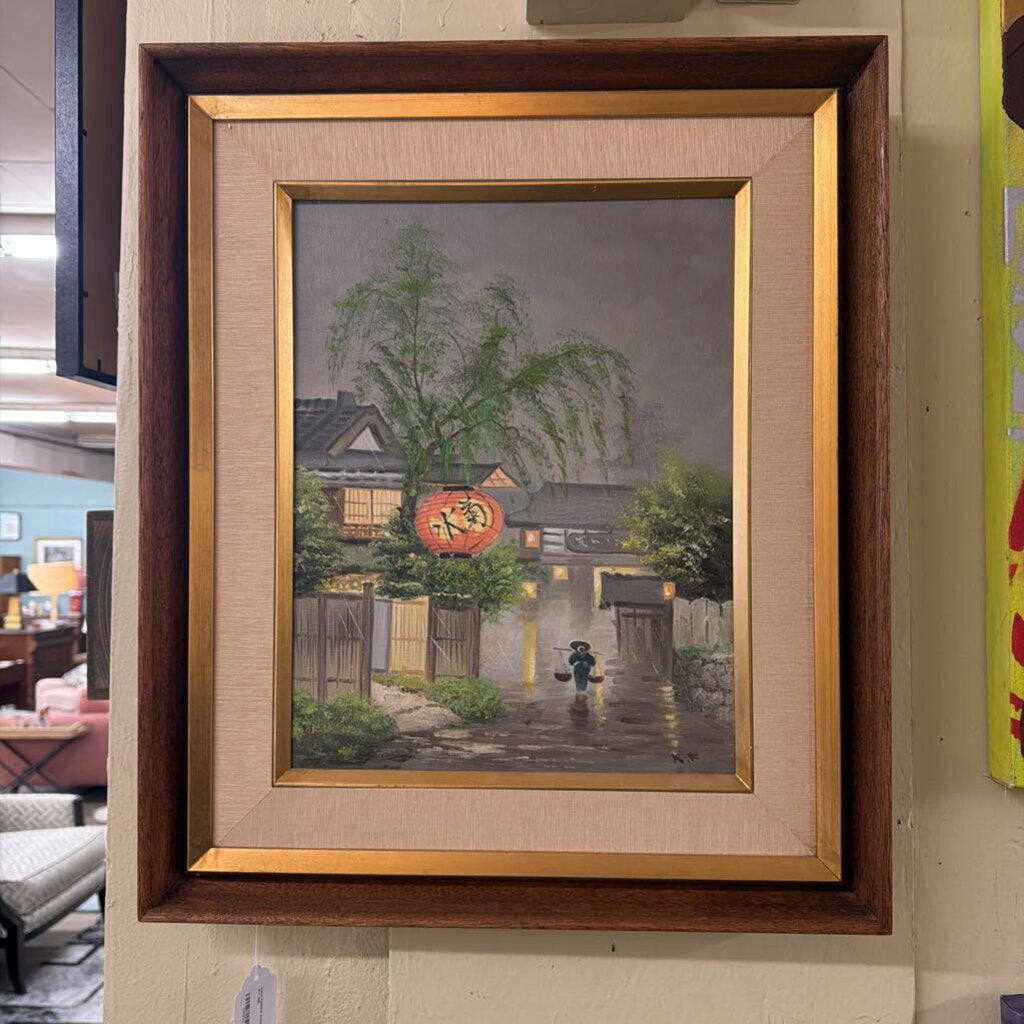 Framed painting of a rainy street scene with a person holding an umbrella.