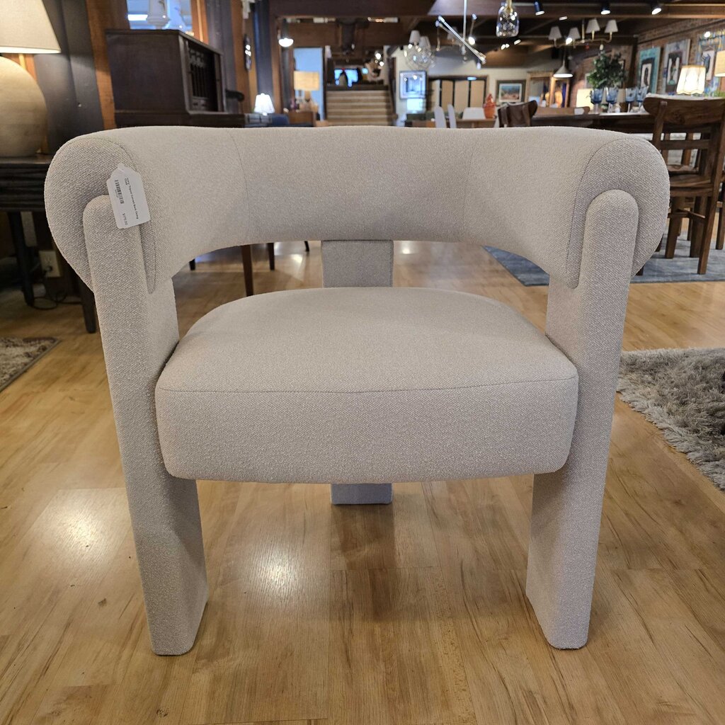 Beige armchair with a tag in a store setting