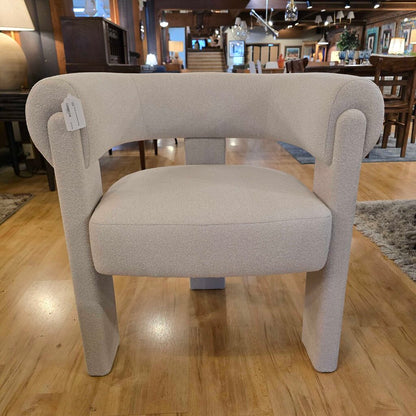 Beige armchair with a tag in a store setting