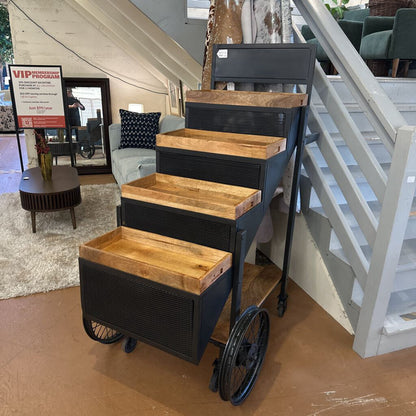 Step stool with wooden platforms and metal frame in a home setting