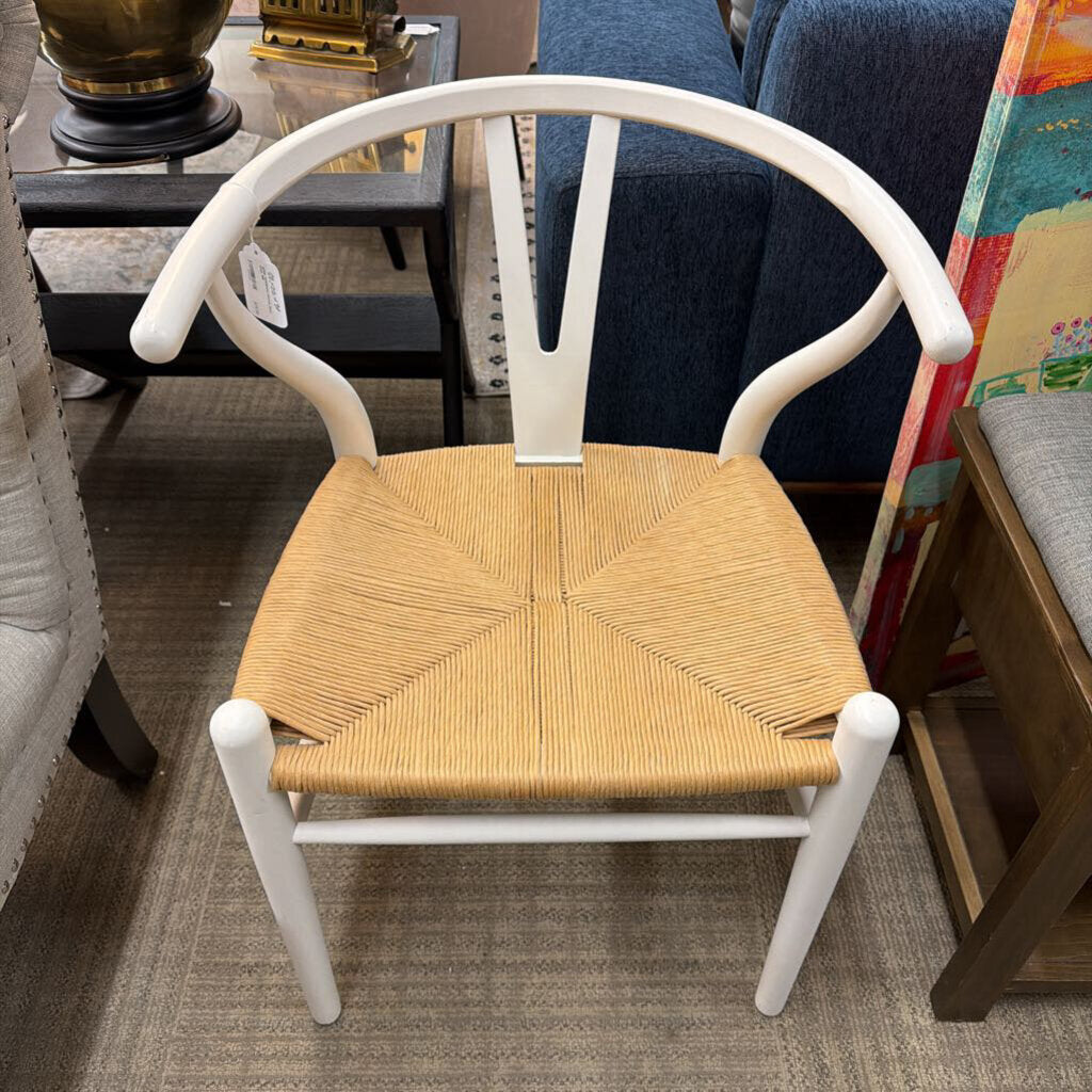 Chair with woven seat and white frame in a room setting