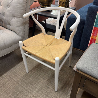 Chair with woven seat and white frame in a living room setting