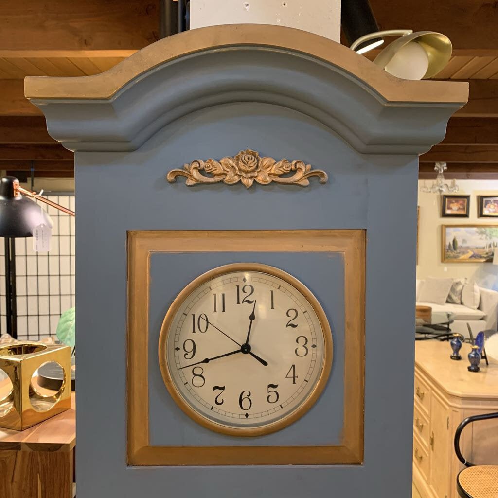 Decorative clock with blue and gold design in a home setting