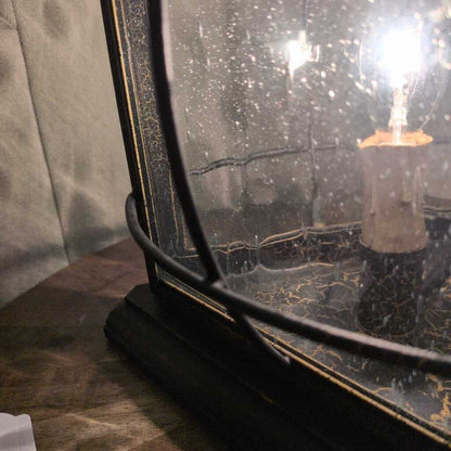 Vintage-style lamp with a light bulb inside a textured glass shade.