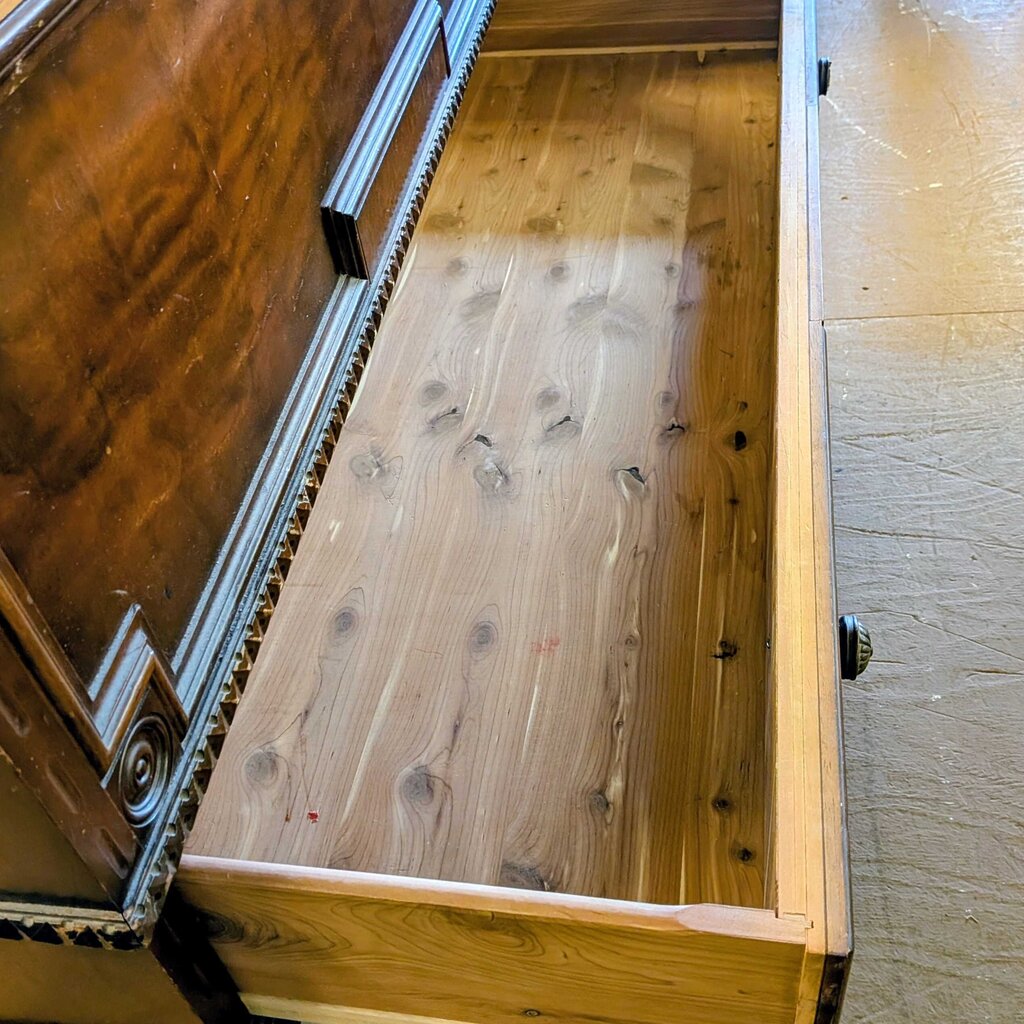 Wooden drawer with metal handle on a wooden floor