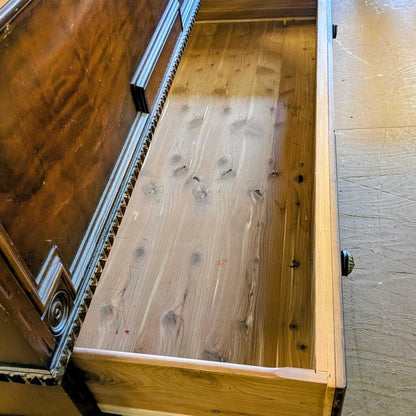 Wooden drawer with metal handle on a wooden floor