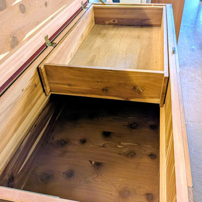 Wooden storage box with a lid open, revealing a dark interior.