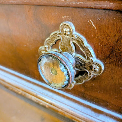 Decorative wooden drawer with ornate metal handle
