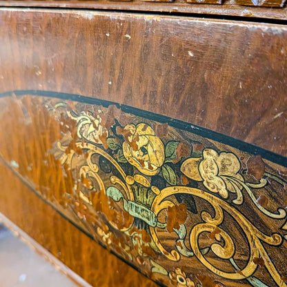 Close-up of an ornate wooden surface with intricate carvings and inlays.