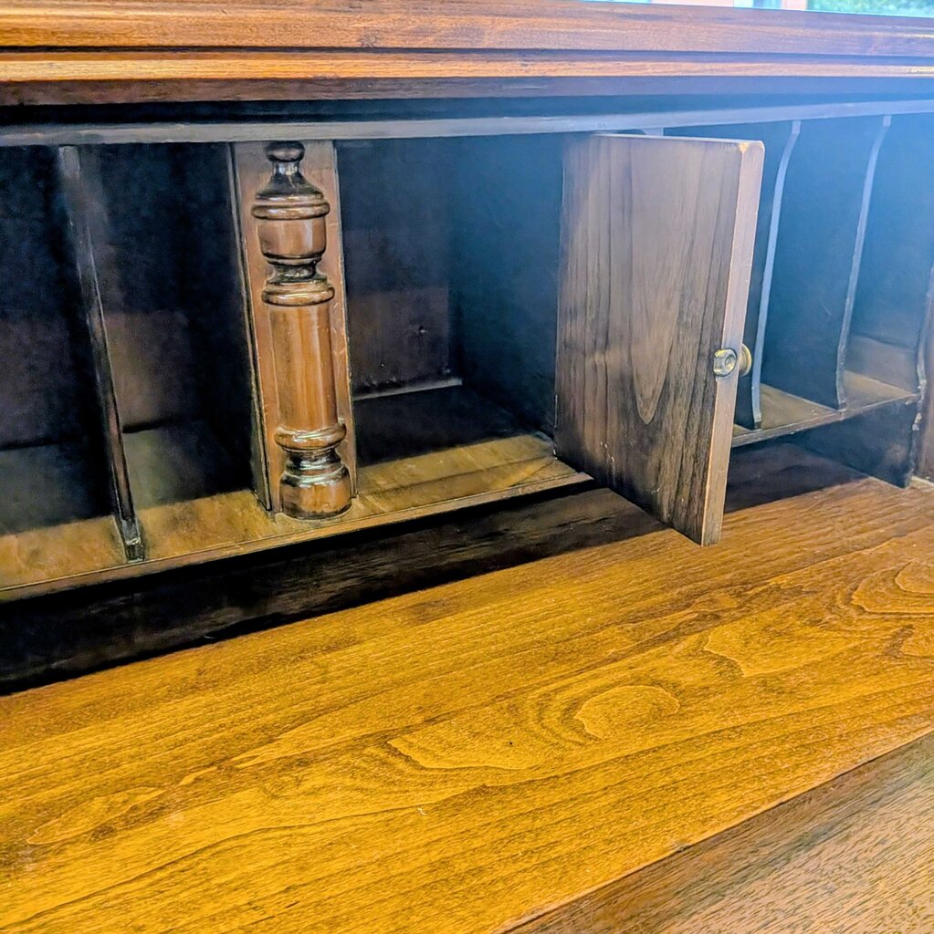 Wooden cabinet with a door open, revealing a shelf inside.
