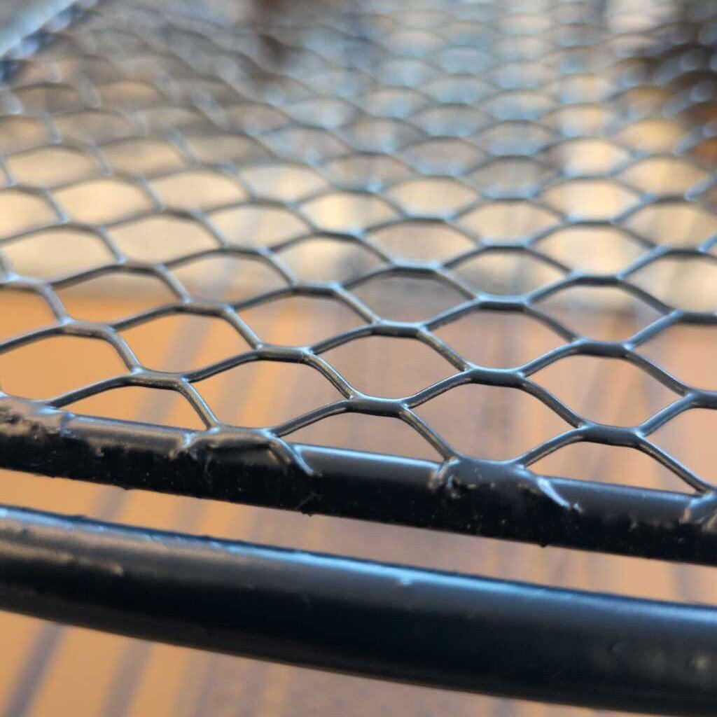 Close-up of a metal grid with a blurred background