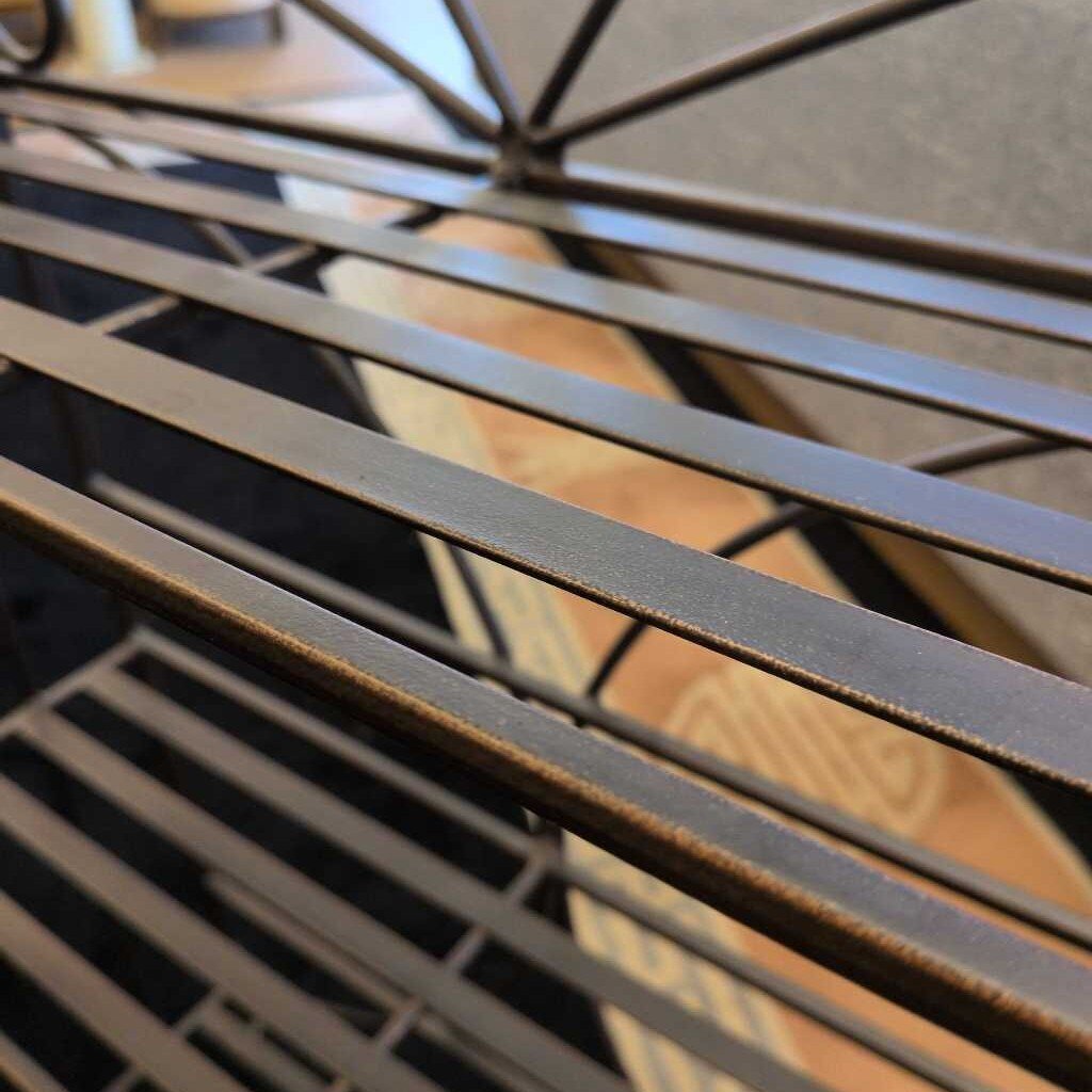 Close-up of a metal lattice structure with a blurred background