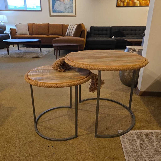 Two wooden tables with metal legs in a living room setting.