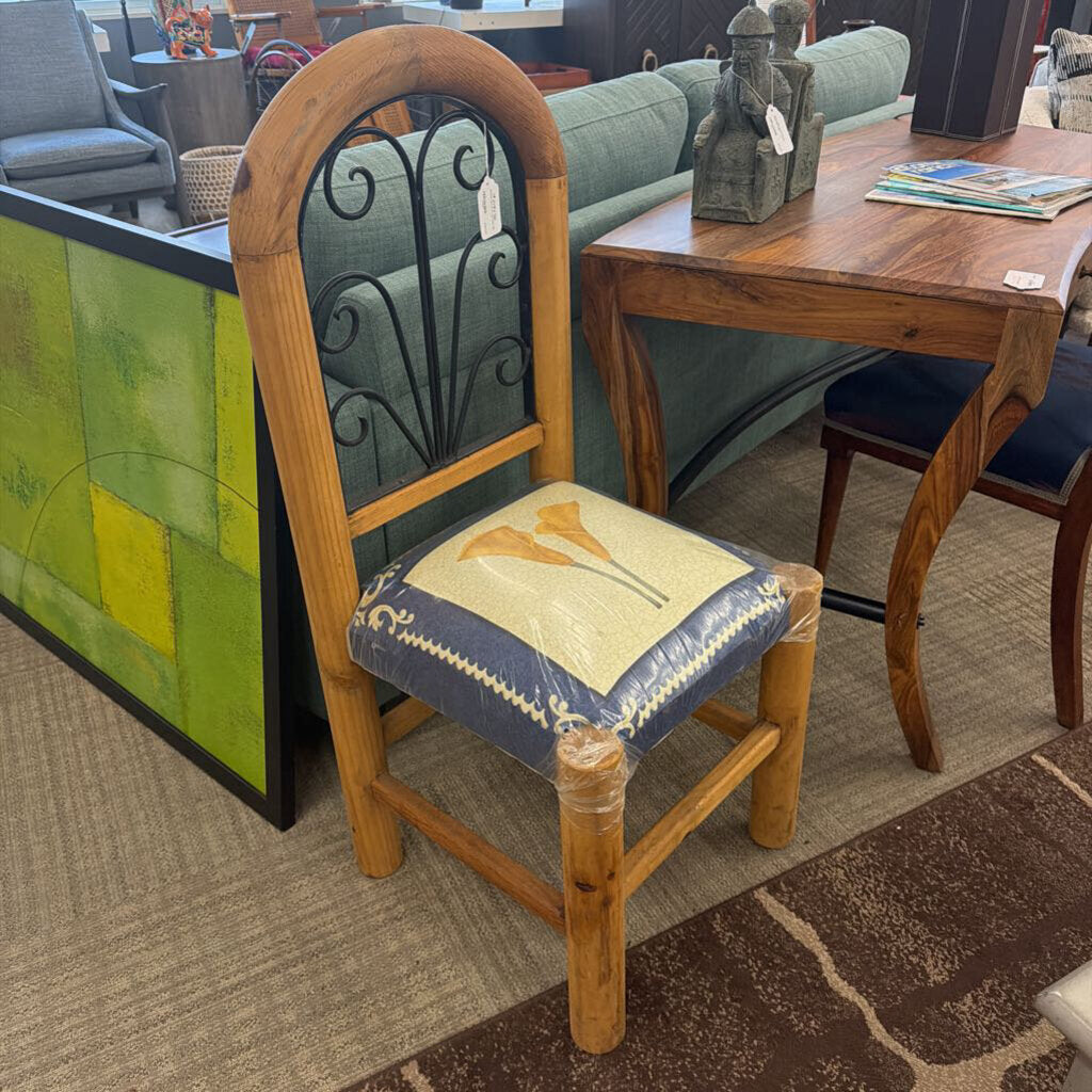 Wooden chair with a decorative cushion in a furniture store setting