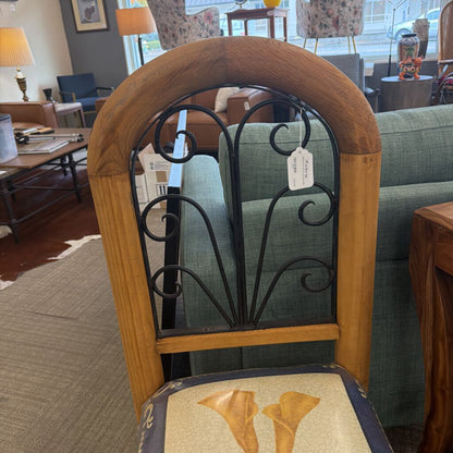 Chair with wooden frame and decorative backrest in a room setting