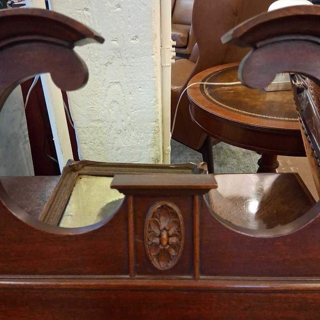 Close-up of an ornate wooden object with intricate carvings.