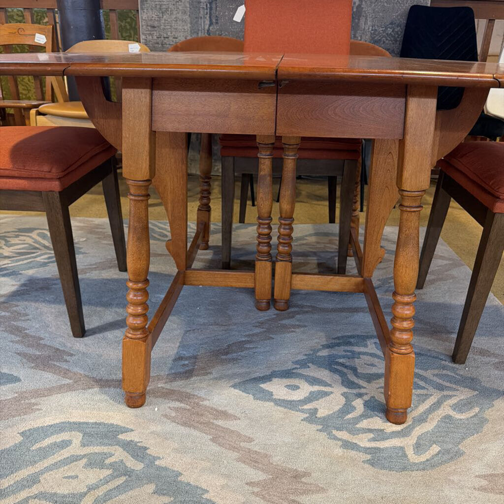 Wooden dining table with chairs on a patterned rug