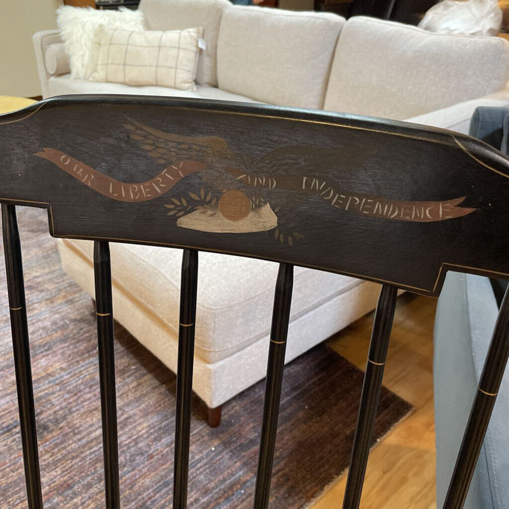 Decorative table with eagle design and text in a living room setting