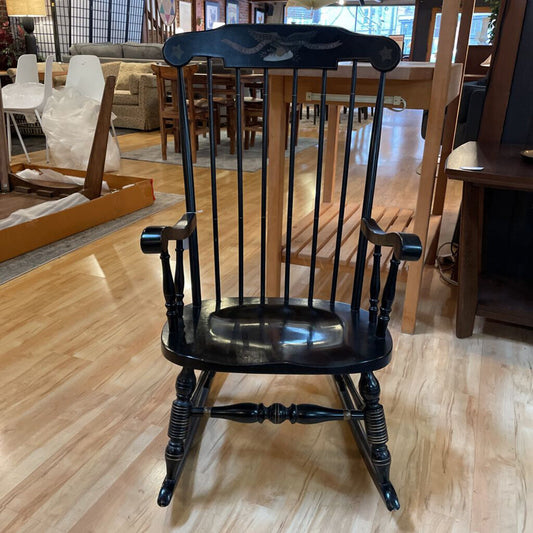 Black rocking chair on a wooden floor in a furniture store
