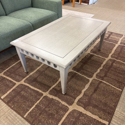 Coffee table on a patterned rug in a living room setting