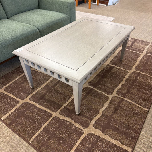 Coffee table on a patterned rug in a living room setting