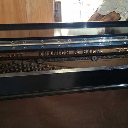 Metallic object with 'Krauss & Bauch' branding on a wooden surface