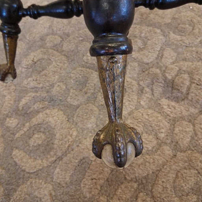 Close-up of a decorative metal foot on a textured surface