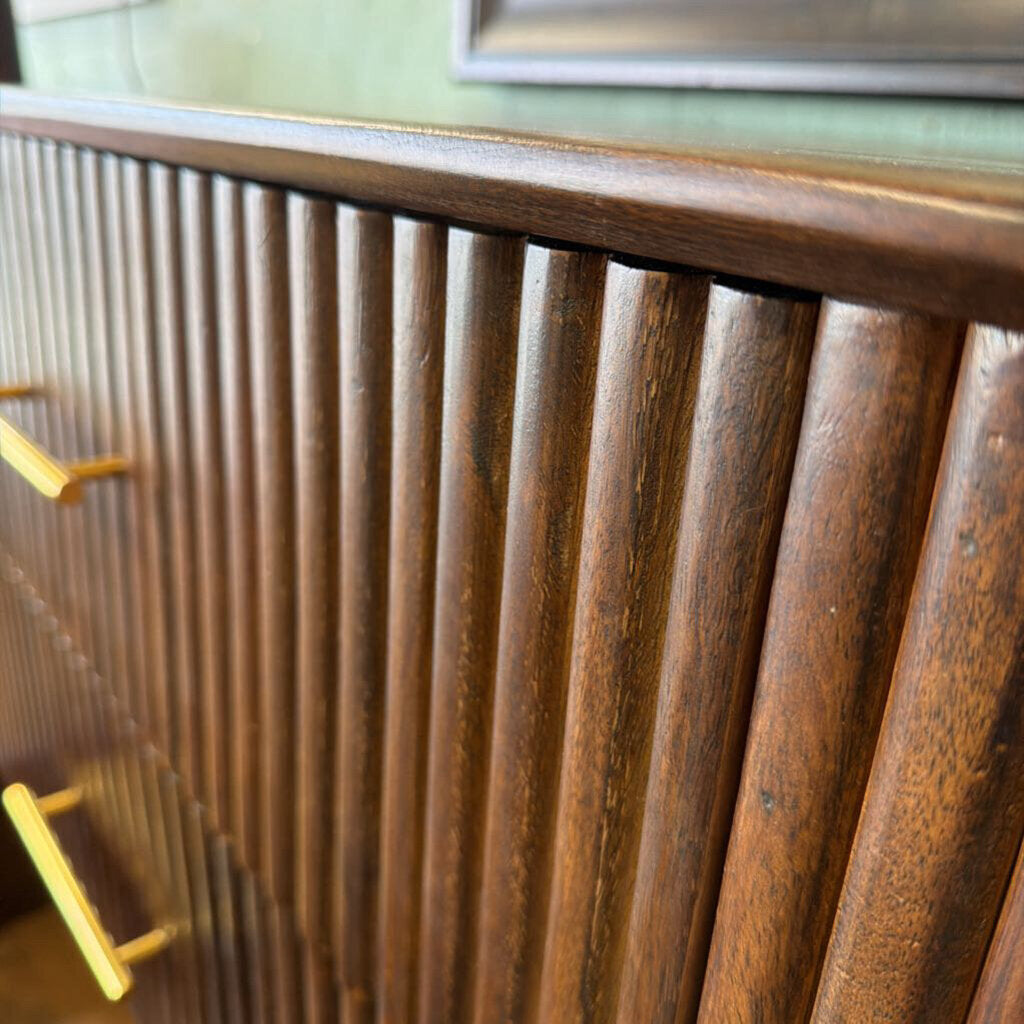 Close-up of a wooden cabinet with glass doors and a yellow handle.