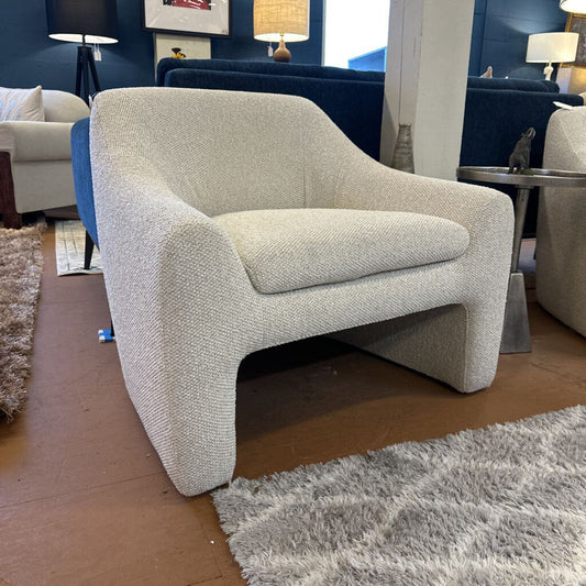 Gray armchair in a room with other furniture and decor