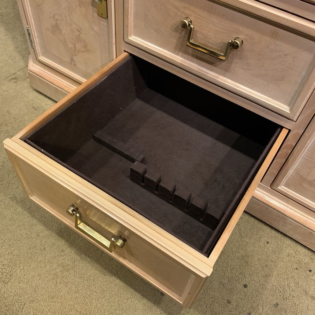 Wooden jewelry box with an open drawer containing black velvet lining.