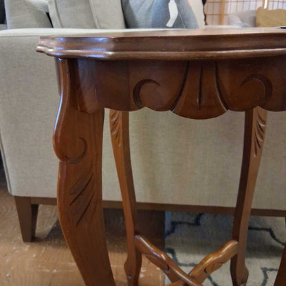 Wooden table with intricate carvings in a room setting