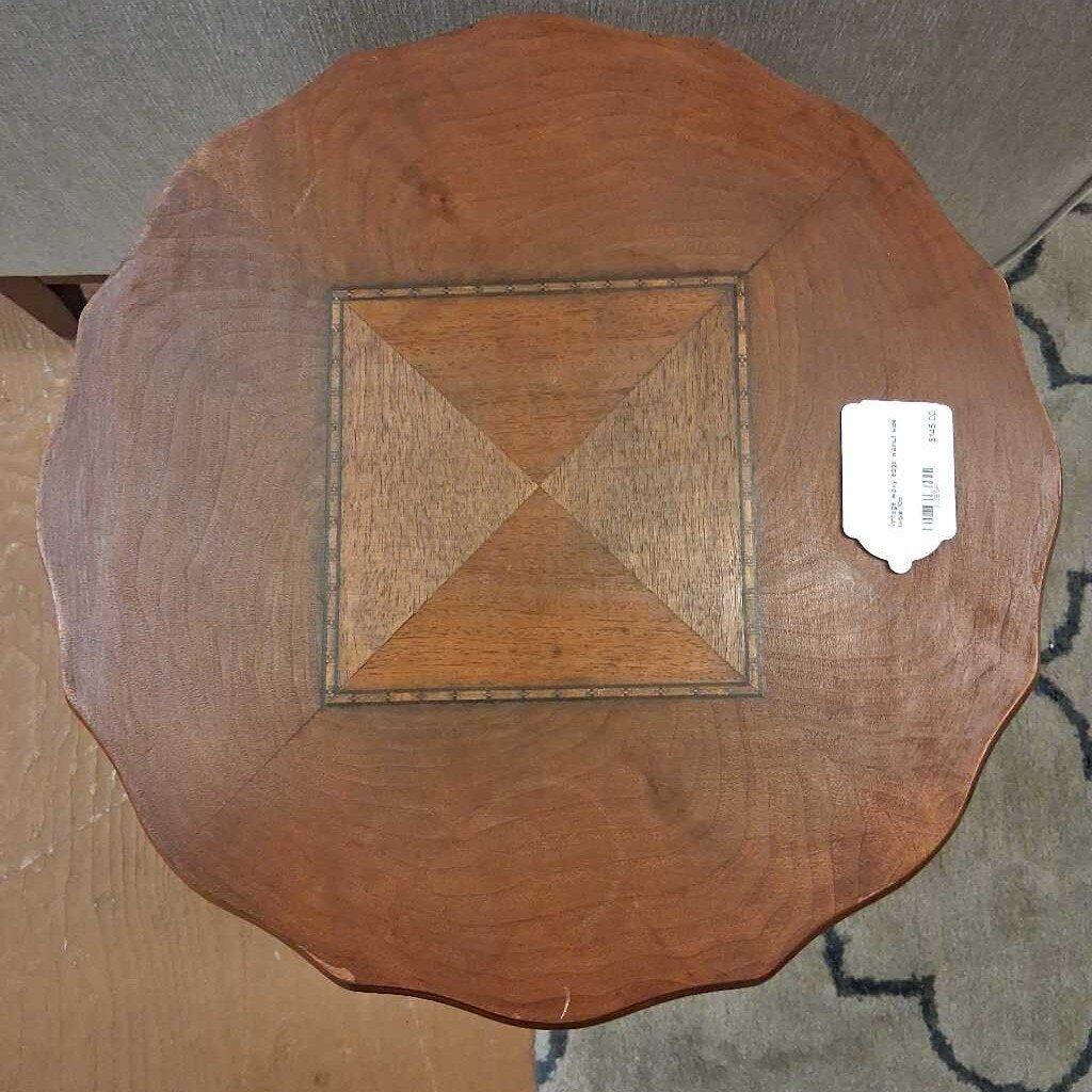 Wooden table with intricate carvings in a room setting