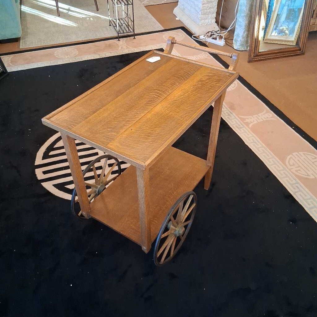 Wooden cart with wheels on a black floor