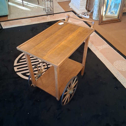 Wooden cart with wheels on a black floor