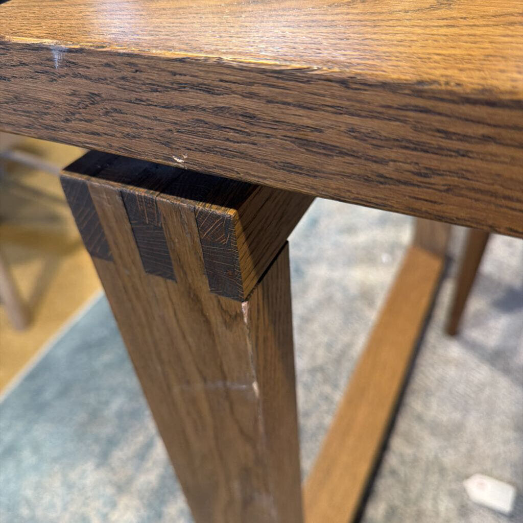 Close-up of a wooden table leg with a visible joint.