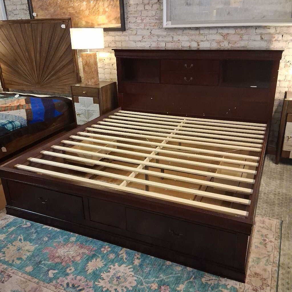Wooden bed frame with storage drawers on a patterned rug